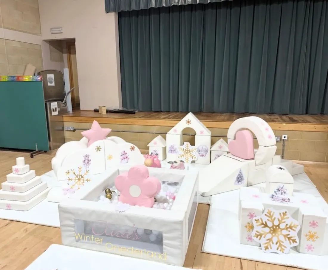 White and pink winter-themed soft play with ball pit, snowflakes and stars
